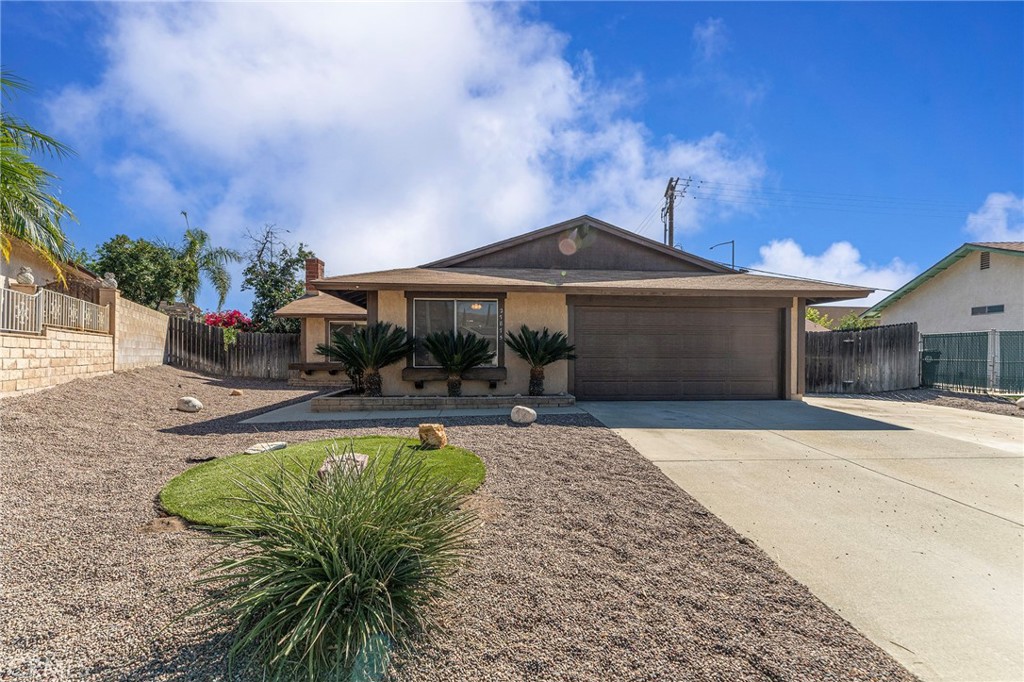27875 Rainbow Lane Highland, CA 92346 - Photo 30 of 37 a patio with a table and chairs under an umbrella