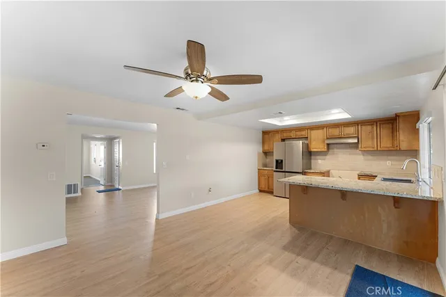 a view of a kitchen with a sink stainless steel appliances and cabinets