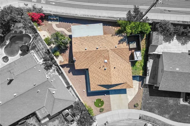 an aerial view of a house with a yard and potted plants