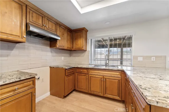a kitchen with a sink stove and cabinets
