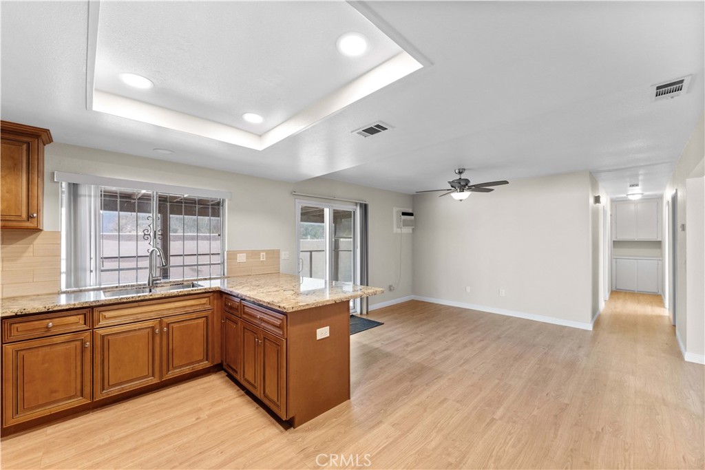 27875 Rainbow Lane Highland, CA 92346 - Photo 6 of 37 a view of a kitchen with a sink and wooden cabinets