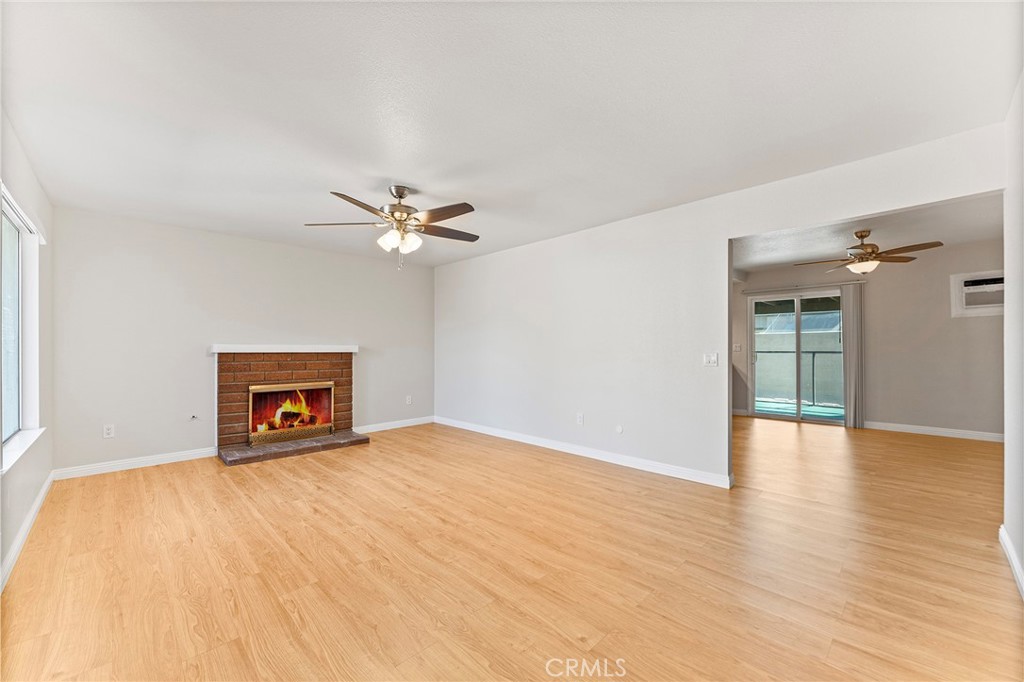 27875 Rainbow Lane Highland, CA 92346 - Photo 7 of 37 a view of an empty room with wooden floor and a ceiling fan