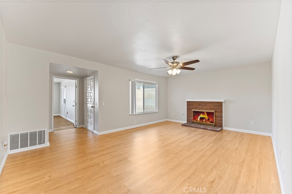 27875 Rainbow Lane Highland, CA 92346 - Photo 8 of 37 a view of an empty room with window and wooden floor