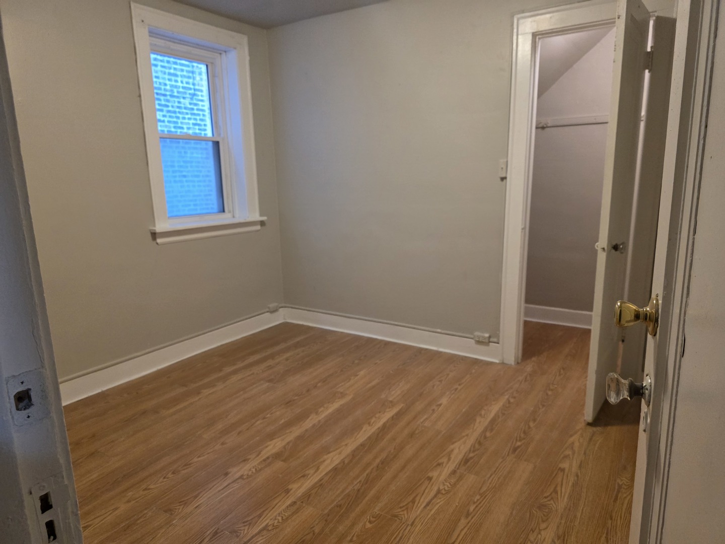 311 Memorial Drive, Unit 1 Calumet City, IL 60409 - Photo 3 of 7 a view of an empty room with wooden floor and a window