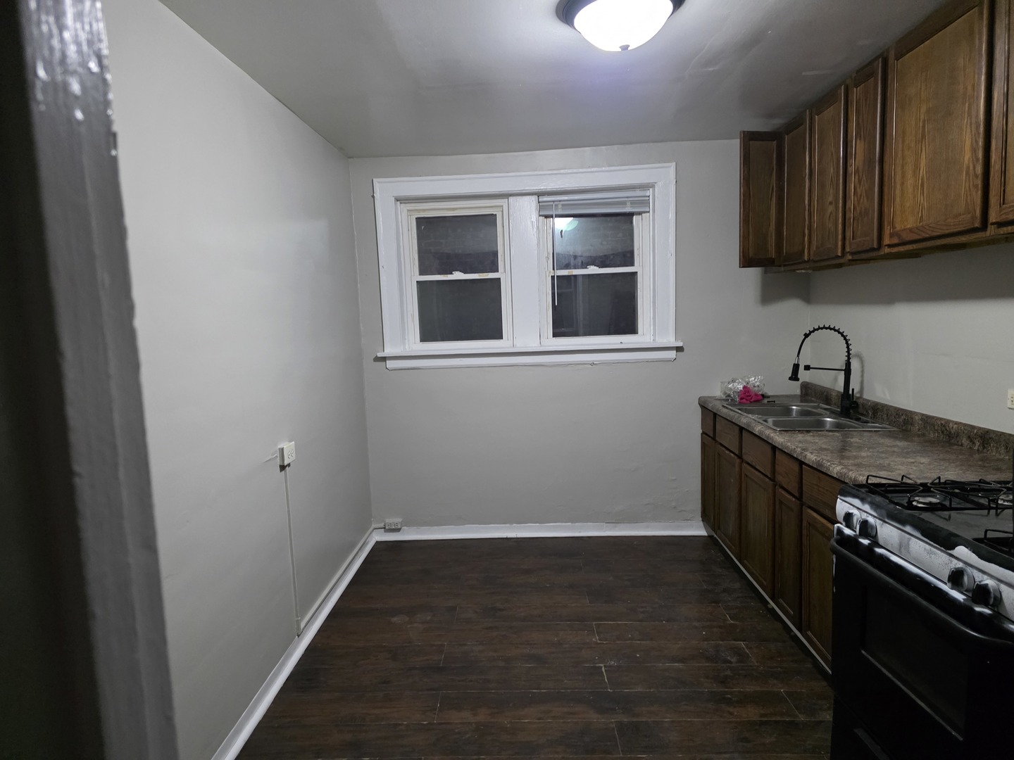311 Memorial Drive, Unit 1 Calumet City, IL 60409 - Photo 6 of 7 a kitchen with a stove and a sink