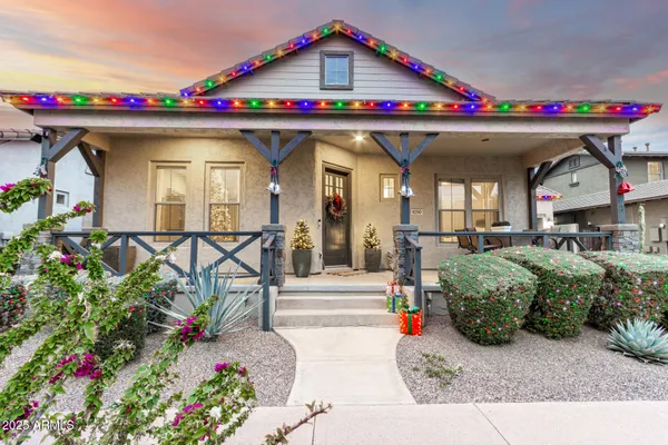 a front view of a house with plants