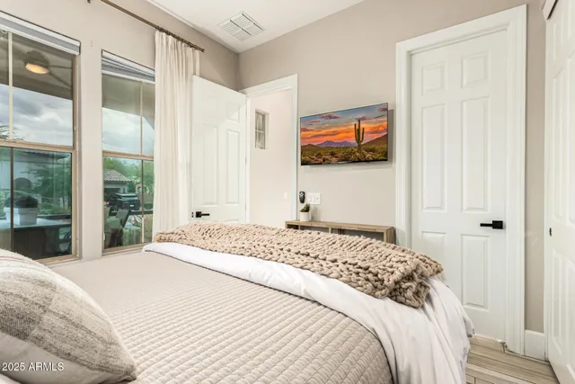 a view of a patio with couches table and chairs and floor to ceiling window