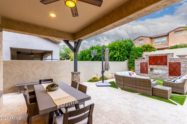 a view of a patio with a table and chairs under an umbrella