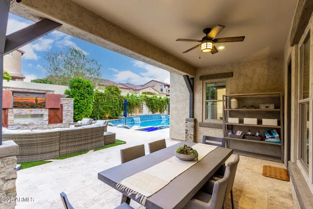 a view of a house with a big yard and sitting area