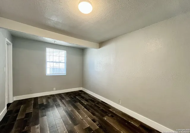 a view of room with wooden floor