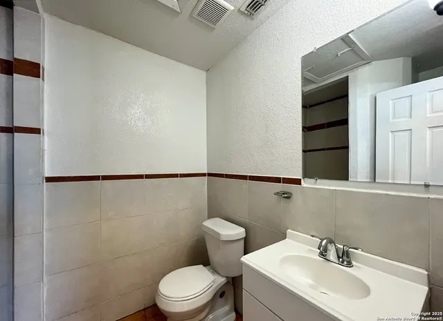 a bathroom with a sink a mirror and shower