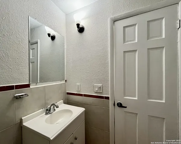 a view of a room with wooden floor and air conditioner