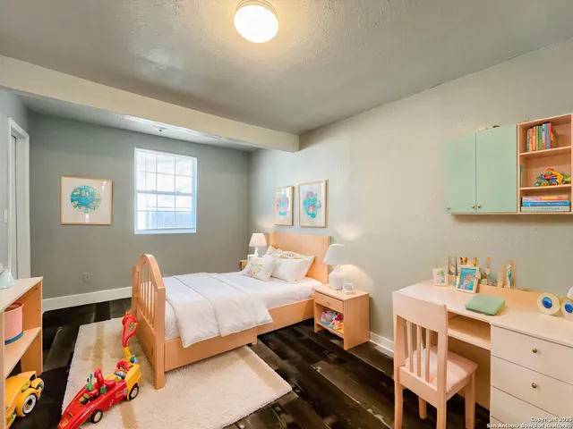 a bedroom with a bed and a window