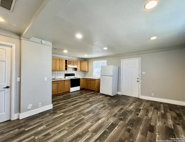 a view of kitchen and kitchen with sink