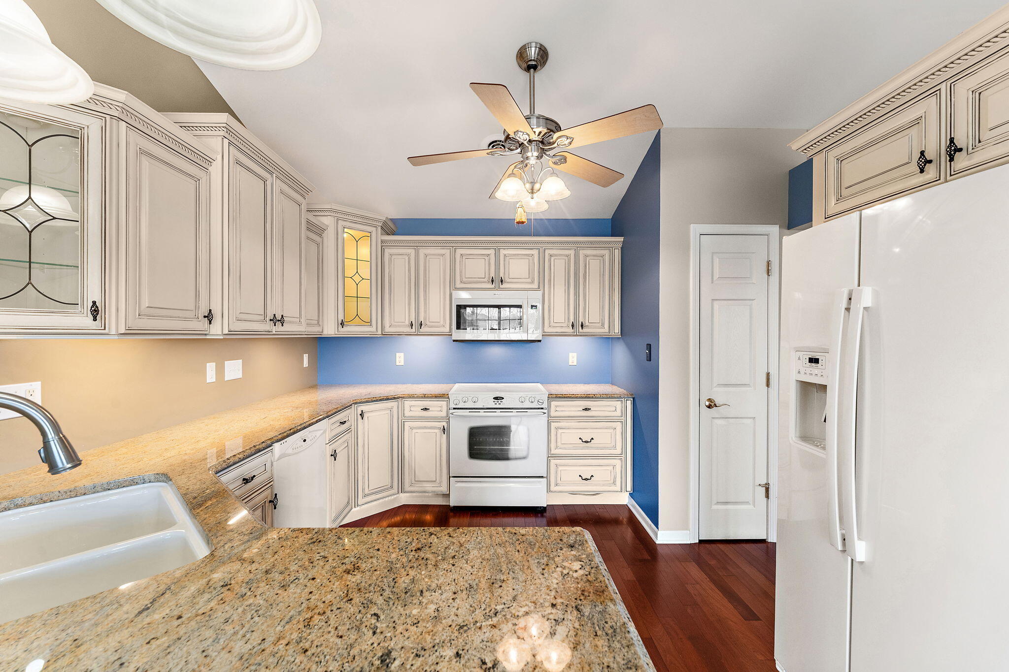 901 Veterans Lane Crown Point, IN 46307 - Photo 15 of 40 a kitchen with stainless steel appliances granite countertop a refrigerator a stove and white cabinets with wooden floor