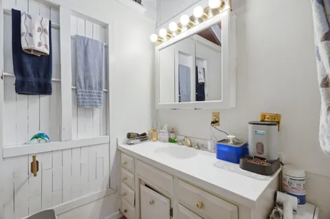 a bathroom with a sink a mirror and vanity
