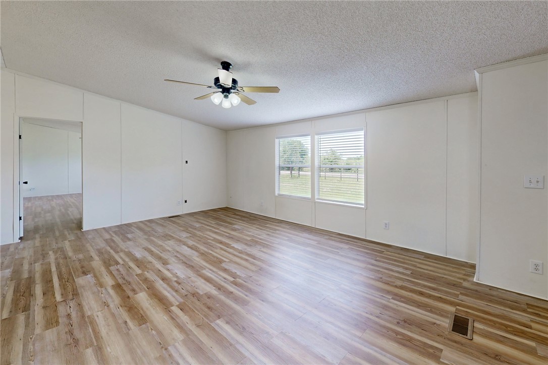 11459 Winstead Lane Calvert, TX 77837 - Photo 6 of 37 a view of empty room with wooden floor and fan