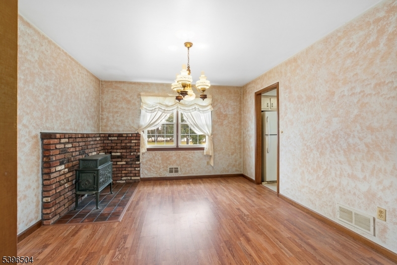 10 Red Oak Way Bridgewater, NJ 08807 - Photo 7 of 30 an empty room with wooden floor fireplace and windows