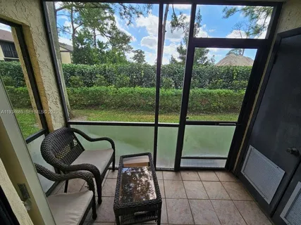 a view of a chairs and table in balcony