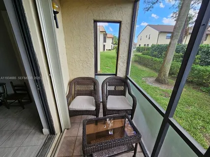a view of a hardwood floor and furniture