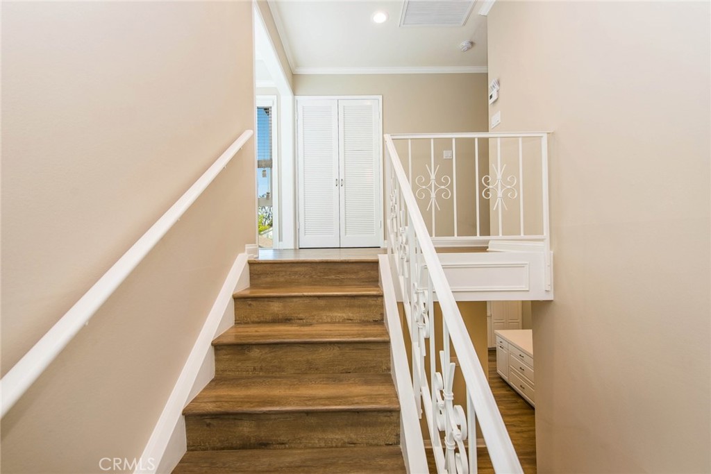 20 Acacia Tree Lane Irvine, CA 92612 - Photo 14 of 44 a view of staircase with wooden floor and white walls