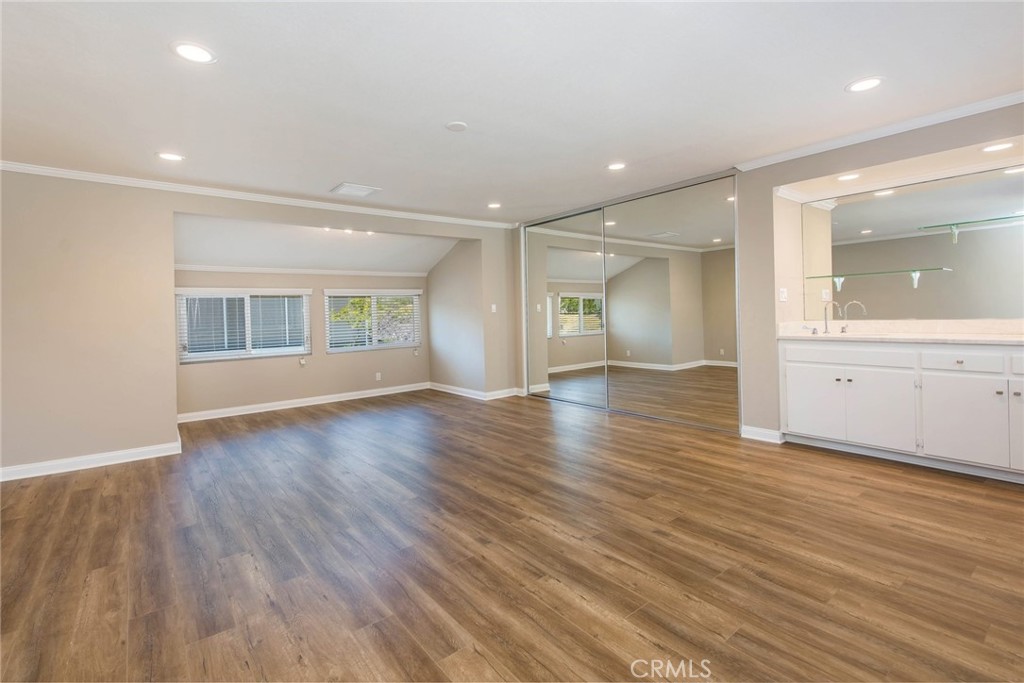20 Acacia Tree Lane Irvine, CA 92612 - Photo 16 of 44 an empty room with wooden floor and windows