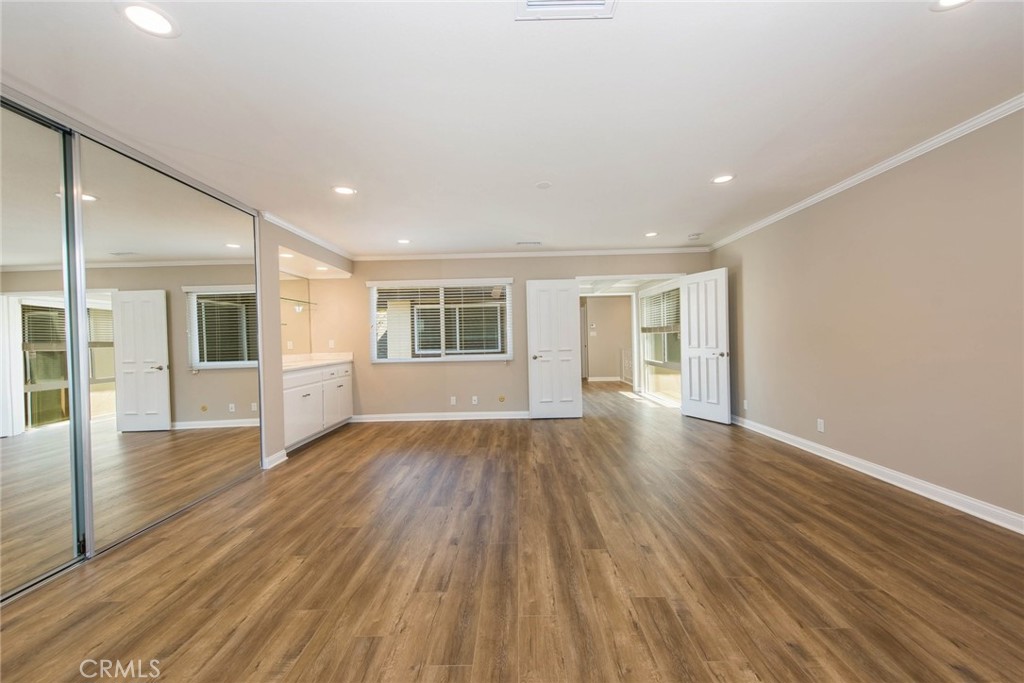 20 Acacia Tree Lane Irvine, CA 92612 - Photo 17 of 44 an empty room with wooden floor and windows