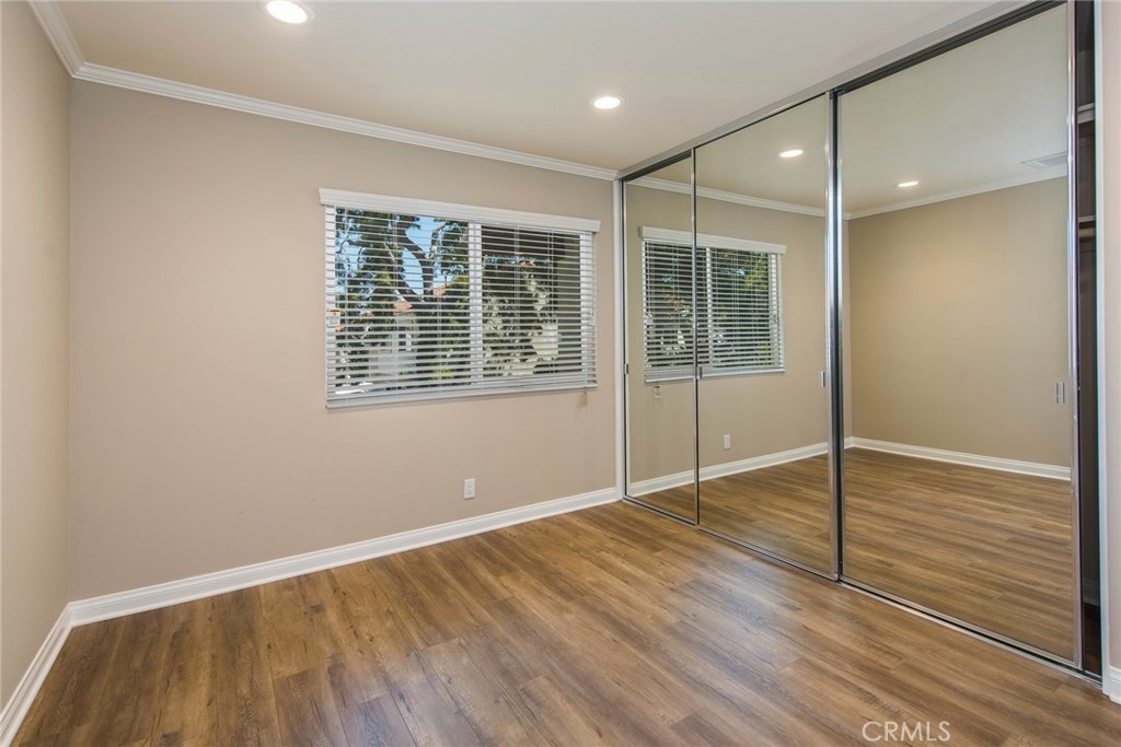 20 Acacia Tree Lane Irvine, CA 92612 - Photo 20 of 44 a view of an empty room with wooden floor and a window