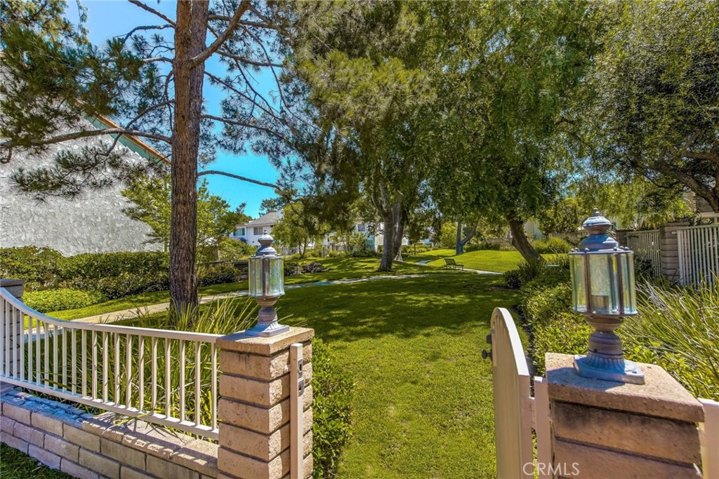 20 Acacia Tree Lane Irvine, CA 92612 - Photo 29 of 44 a view of a table and chairs in the deck under a large tree