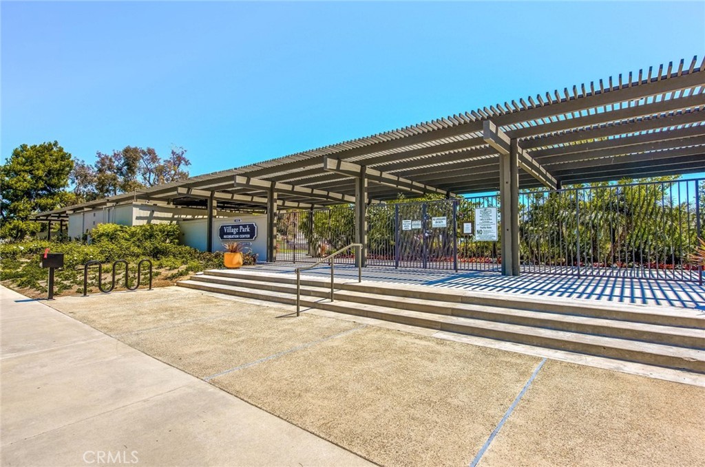 20 Acacia Tree Lane Irvine, CA 92612 - Photo 41 of 44 a view of a patio with a table and chairs under an umbrella