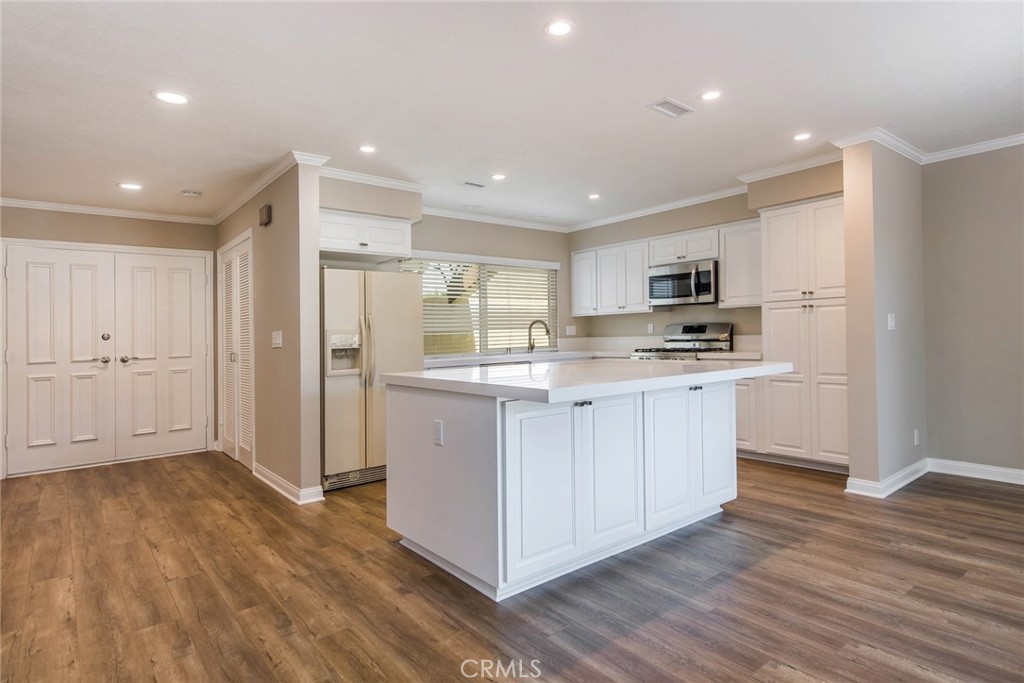 20 Acacia Tree Lane Irvine, CA 92612 - Photo 6 of 44 a kitchen with white cabinets and stainless steel appliances