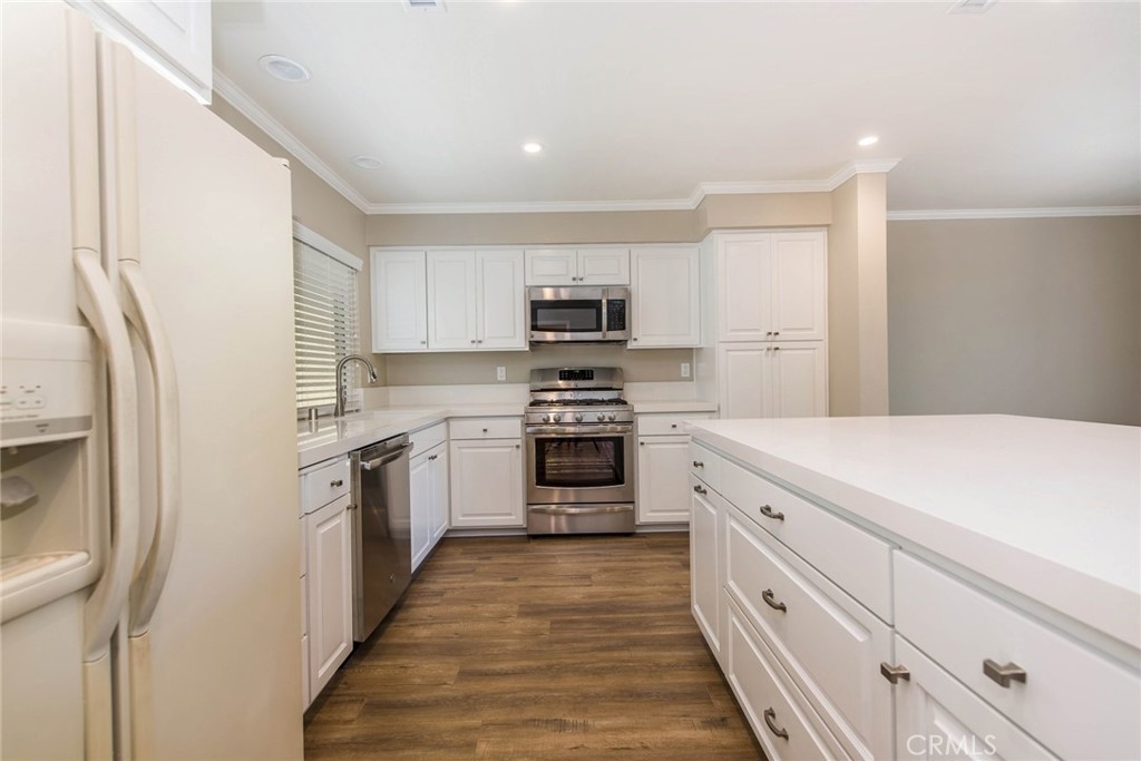 20 Acacia Tree Lane Irvine, CA 92612 - Photo 8 of 44 a kitchen with granite countertop a refrigerator stove and oven