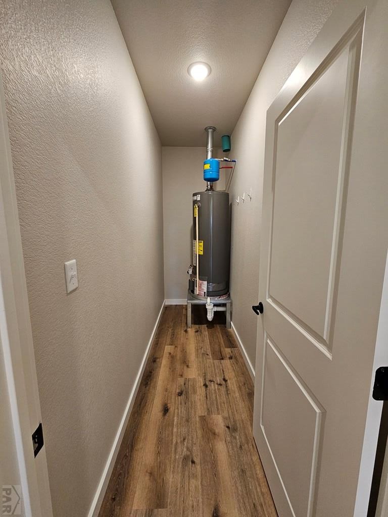 28651 County Road 24.6 Springfield, CO 81073 - Photo 11 of 18 a view of a hallway with wooden floor and a bathroom