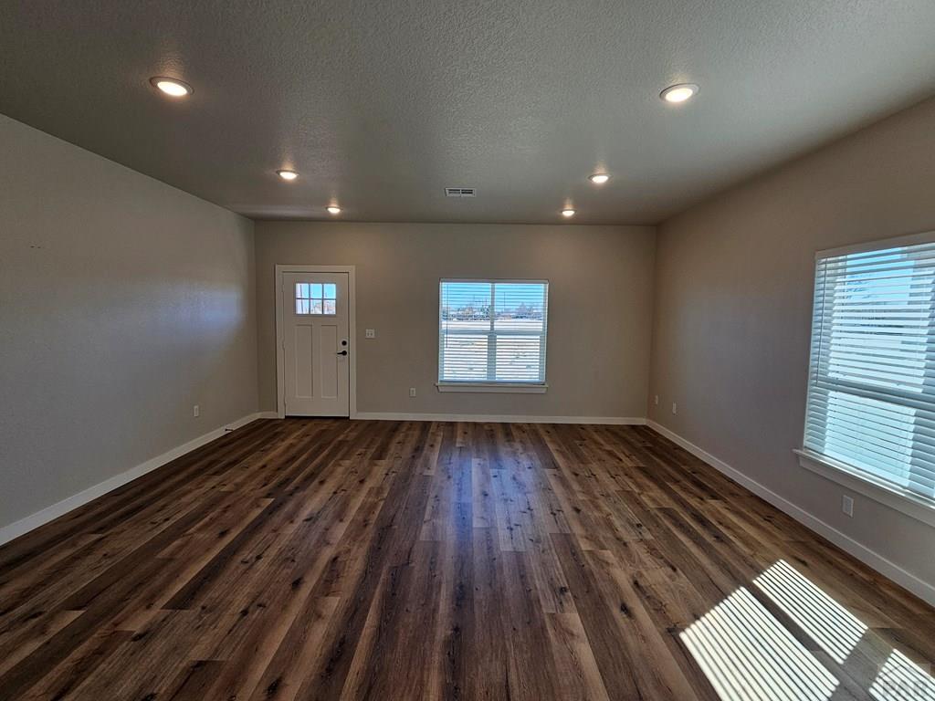 28651 County Road 24.6 Springfield, CO 81073 - Photo 3 of 18 an empty room with wooden floor and windows