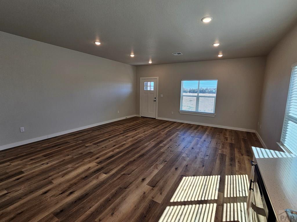 28651 County Road 24.6 Springfield, CO 81073 - Photo 4 of 18 a view of an empty room with wooden floor and a window