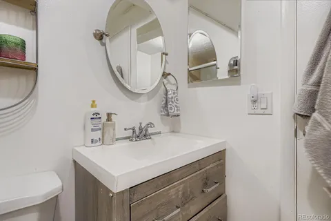a bathroom with a sink vanity and a mirror
