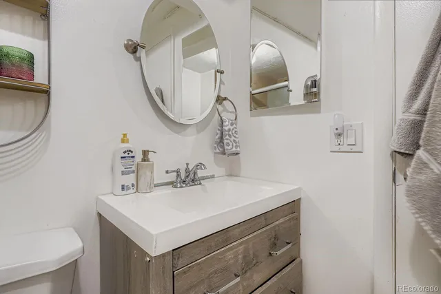 a bathroom with a sink vanity and a mirror