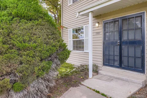 a view of house with backyard and wooden fence