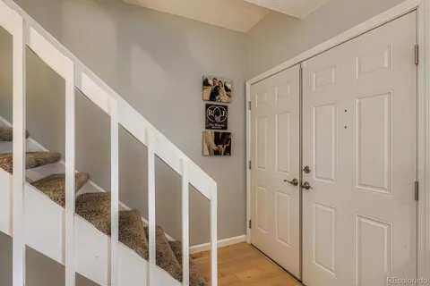 a view of a hallway with wooden floor and entryway