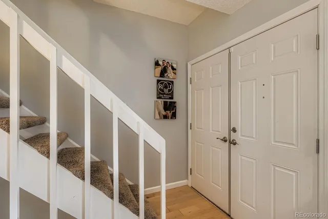 a view of a hallway with wooden floor and entryway