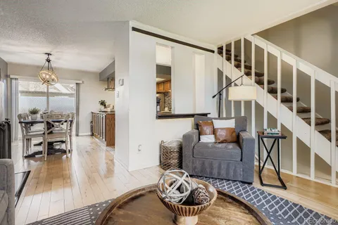 a living room with furniture and a wooden floor