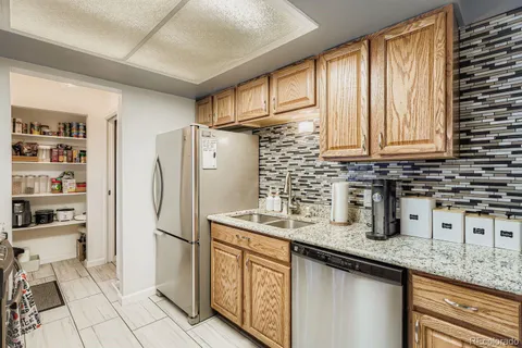 a kitchen with stainless steel appliances granite countertop a refrigerator sink and cabinets