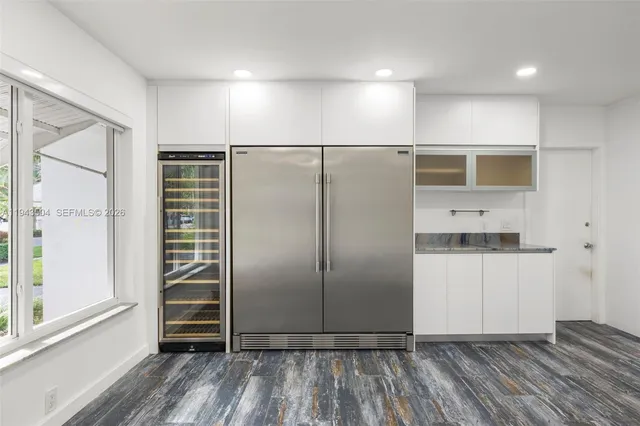 a view of a refrigerator in kitchen and wooden floor