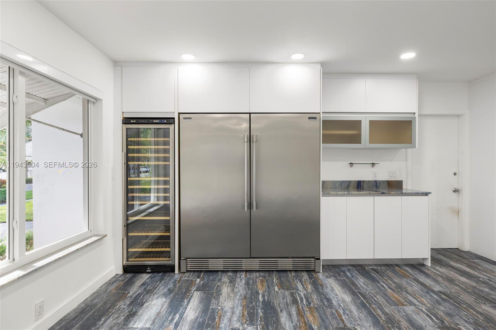 1895 Ixora Road North Miami, FL 33181 - Photo 11 of 42 a view of a refrigerator in kitchen and wooden floor