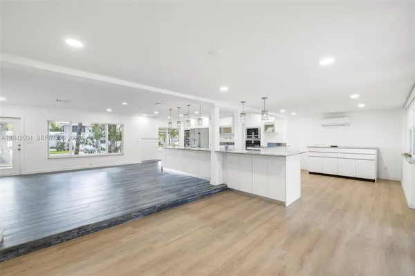 a view of kitchen with kitchen island and stainless steel appliances