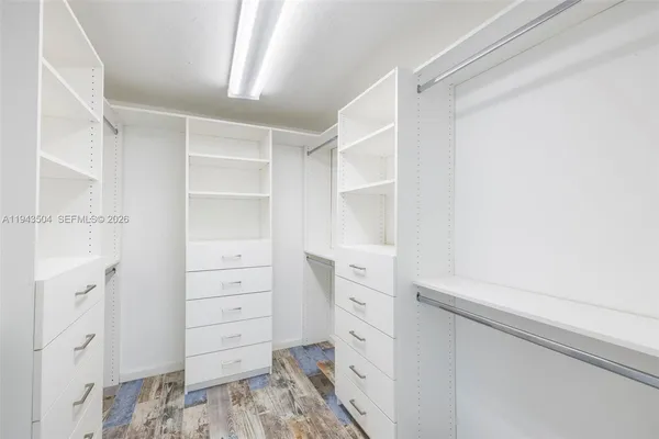 a view of walk in closet with cabinet
