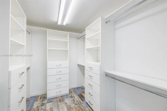 a view of walk in closet with cabinet