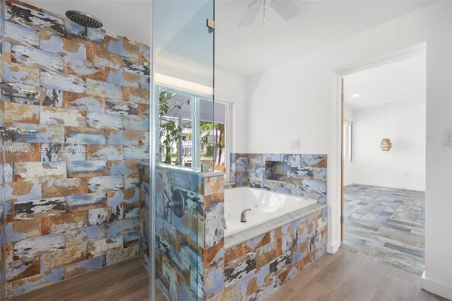 a bathroom with a bathtub and shower