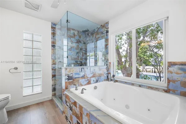 a bathroom with a bathtub and a shower