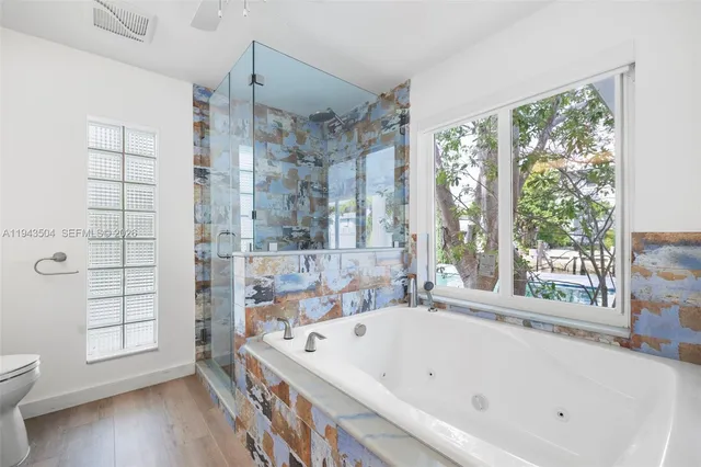 a bathroom with a bathtub and a shower